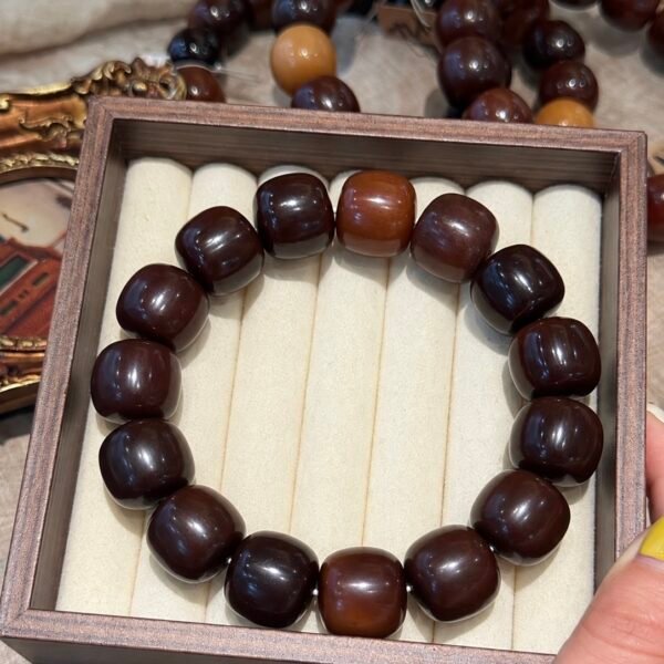 Oversized dark brown 18–19mm barrel-shaped Bodhi bracelet displayed in a wooden jewelry tray.