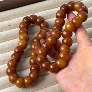 CARAMEL CLOVE bracelet with glossy 16mm garlic-clove-shaped Bodhi beads in warm golden and caramel-brown tones